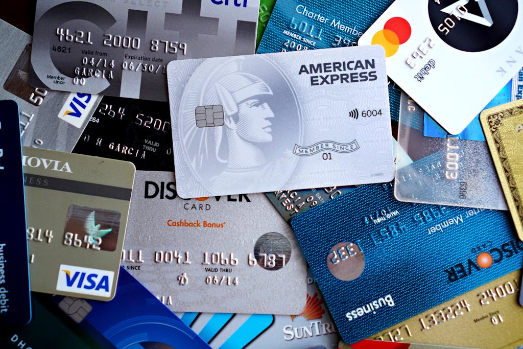 Close-up image of various credit and debit cards including Visa, MasterCard, American Express, and Discover.
