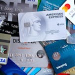 Close-up image of various credit and debit cards including Visa, MasterCard, American Express, and Discover.